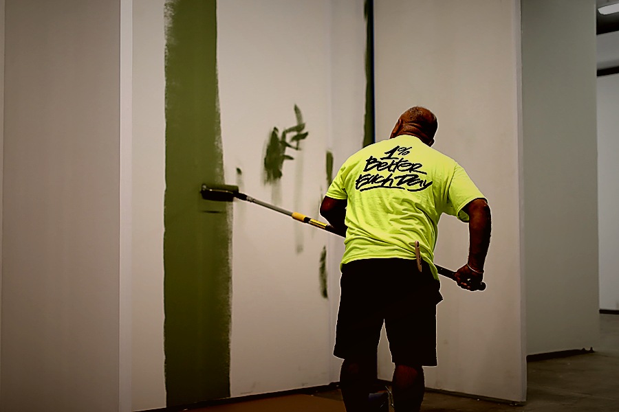 Foti Inc. painter rolling green accent wall in Williamsburg Brooklyn commercial space